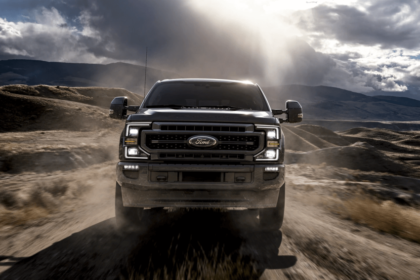 ford f-150 driving off-road on a dirt path